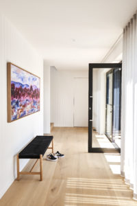 The entrance of Patrick Dangerfield's contemporary home with honey-oak toned Otto XVII Sault European oak flooring