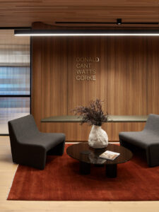 A workspace welcome area with Cellupal Remax Spotted Gum timber-look laminate wall joinery