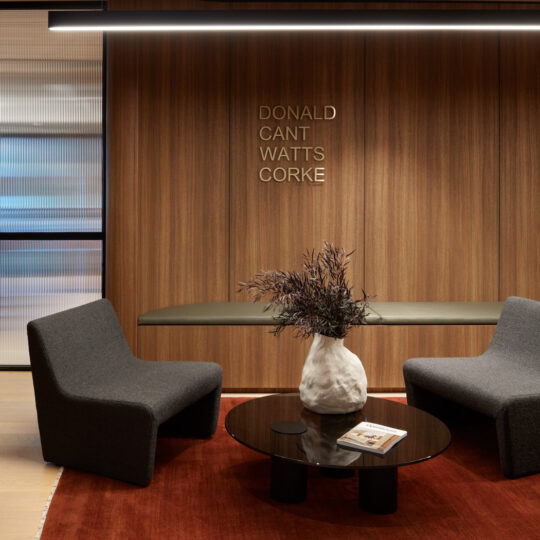 A workspace welcome area with Cellupal Remax Spotted Gum timber-look laminate wall joinery