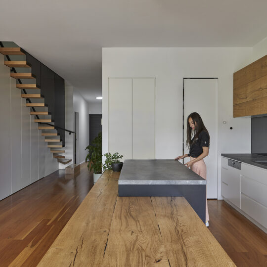 Beautiful Beam Wood Natural Lignapal timber veneer in the kitchen cabinets and island bench of Pomegranate House